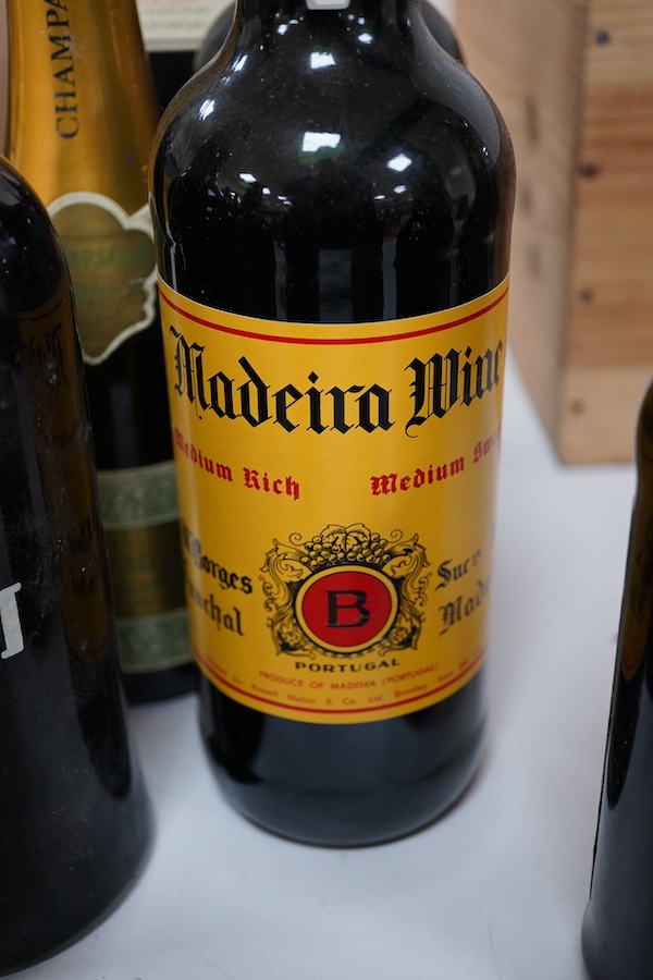 Seven assorted ports including Morgan’s 1985 and three half bottle Fortnum & Mason, together with two Madeira wines and a half bottle of Champagne.